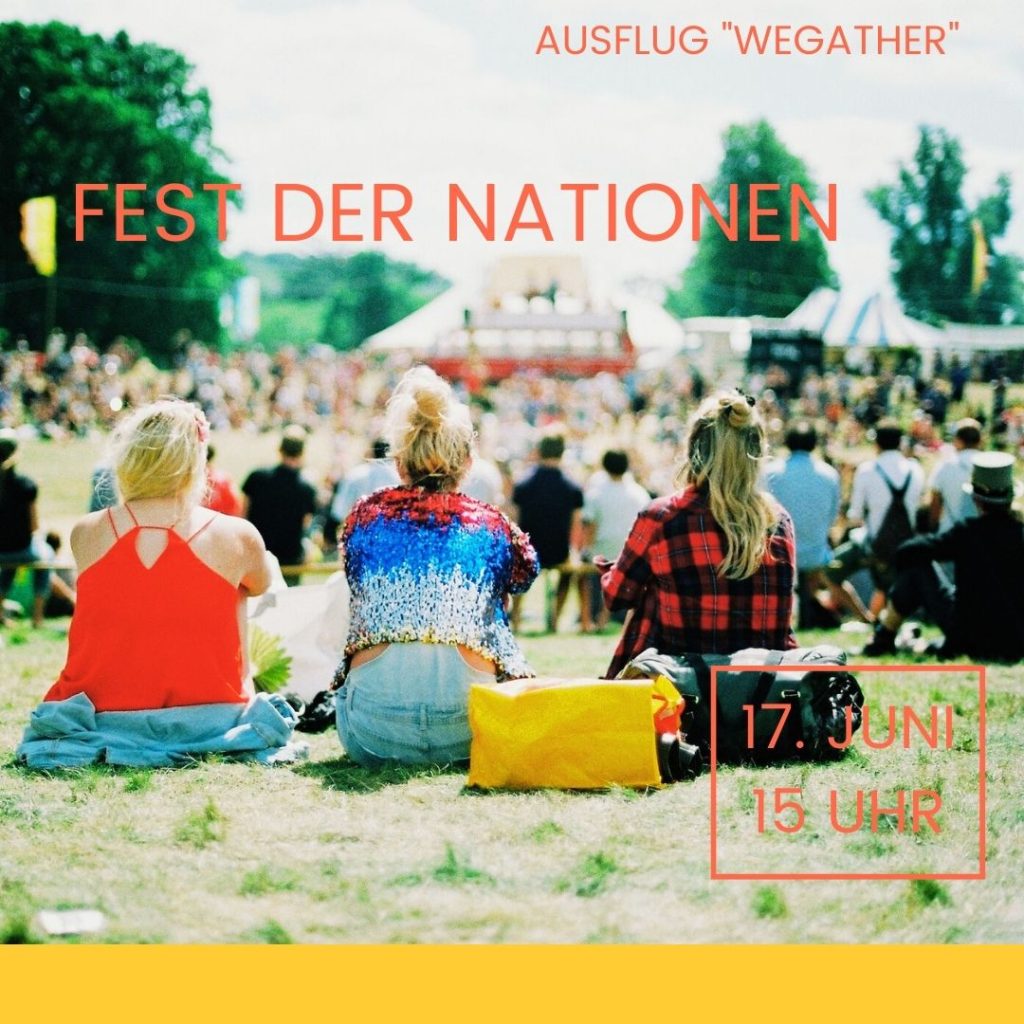 3 women sitting on the grass at a festival